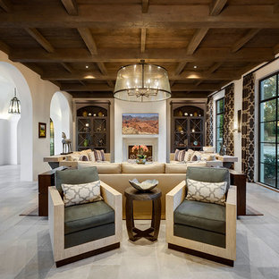 Ejemplo de salón abierto, mediterráneo, extra grande, con paredes blancas, suelo de piedra caliza, suelo gris, estufa de leña y marco de chimenea de piedra