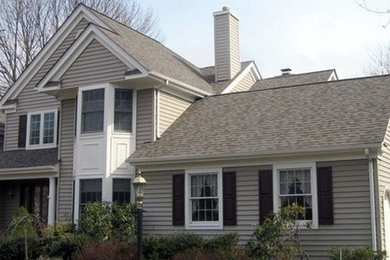 This is an example of a large traditional three-storey beige exterior in Newark with vinyl siding.
