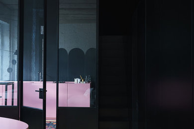 Mid-sized danish concrete floor and beige floor hallway photo in New York with black walls