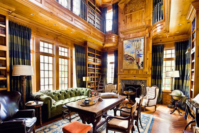This is an example of an expansive enclosed living room in Dallas with a library, medium hardwood floors, a standard fireplace and a stone fireplace surround.