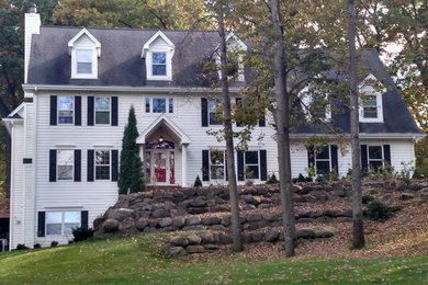 Inspiration for a mid-sized timeless white three-story wood gable roof remodel in Milwaukee