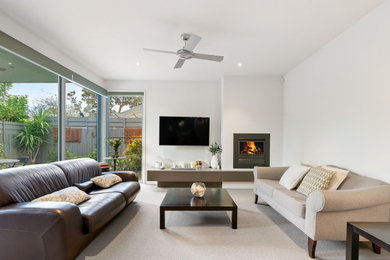 Photo of a small modern family room in Other with a standard fireplace, a concrete fireplace surround and white floor.