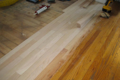 Example of a classic medium tone wood floor hallway design in New York