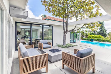 Mid-sized 1950s patio photo in Los Angeles with a fire pit and decking
