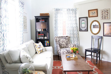 Family room - mid-sized eclectic enclosed dark wood floor family room idea in San Diego with white walls and no tv