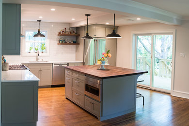 Inspiration for a mid-sized contemporary l-shaped eat-in kitchen in Philadelphia with an undermount sink, shaker cabinets, grey cabinets, quartzite benchtops, yellow splashback, subway tile splashback, stainless steel appliances, medium hardwood floors, with island and brown floor.