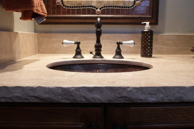 Inspiration for a mid-sized rustic 3/4 bathroom remodel in Phoenix with recessed-panel cabinets, dark wood cabinets, a two-piece toilet, gray walls and an undermount sink