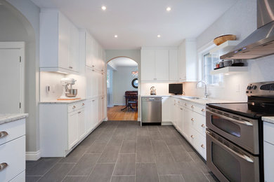 Large minimalist galley porcelain tile enclosed kitchen photo in Other with a drop-in sink, shaker cabinets, white cabinets, white backsplash, stainless steel appliances, no island, quartz countertops and mosaic tile backsplash