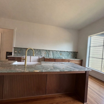 Green quartzite kitchen with full-height slab backsplash