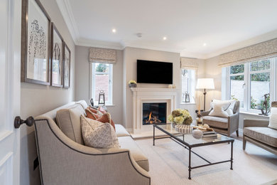 Photo of a contemporary formal and cream and black living room in London with a standard fireplace, a stone fireplace surround, a wall mounted tv, white floors and a chimney breast.