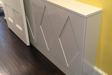 Small eclectic dark wood floor and brown floor entryway photo in Boston with yellow walls