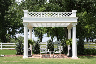 This is an example of a traditional full sun backyard brick landscaping in Jackson.