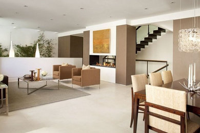 Photo of a mid-sized modern living room in Toronto with white walls, a two-sided fireplace and white floor.
