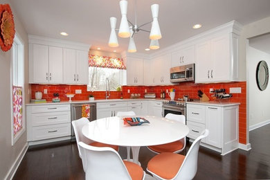 Eat-in kitchen - mid-sized 1950s l-shaped dark wood floor eat-in kitchen idea in Bridgeport with an undermount sink, shaker cabinets, white cabinets, orange backsplash, ceramic backsplash, stainless steel appliances and no island