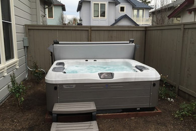 This is an example of a large contemporary back above ground hot tub in San Francisco.