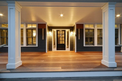 Mid-sized trendy back porch idea in New York with decking and a roof extension