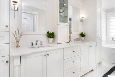 Inspiration for a large transitional master bathroom in Ottawa with white cabinets, a freestanding tub, a two-piece toilet, white walls, an undermount sink and white floor.