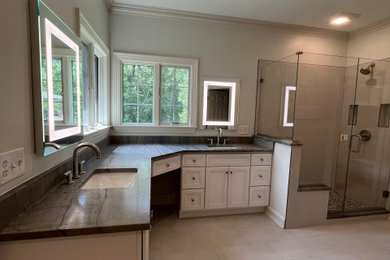 Inspiration for a large modern master beige tile and porcelain tile porcelain tile, white floor and double-sink bathroom remodel in Indianapolis with beaded inset cabinets, white cabinets, a bidet, gray walls, an undermount sink, granite countertops, a hinged shower door and a built-in vanity