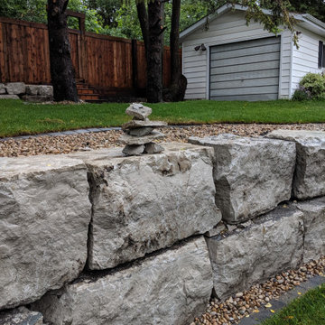 Natural boulder retaining wall in Edmonton
