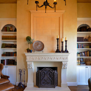 Inspiration for a mediterranean living room in San Francisco with a reading nook, beige walls, medium hardwood flooring and a standard fireplace.