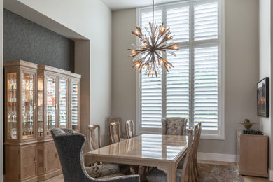 This is an example of a transitional dining room in Austin.
