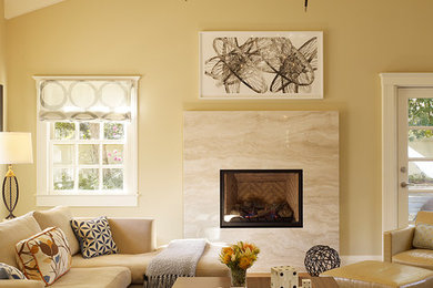 Example of a transitional carpeted family room design in San Francisco with beige walls and a standard fireplace
