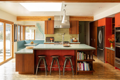 Example of a large mid-century modern l-shaped cork floor, beige floor and exposed beam eat-in kitchen design in Los Angeles with a double-bowl sink, flat-panel cabinets, dark wood cabinets, quartzite countertops, green backsplash, subway tile backsplash, stainless steel appliances, an island and gray countertops