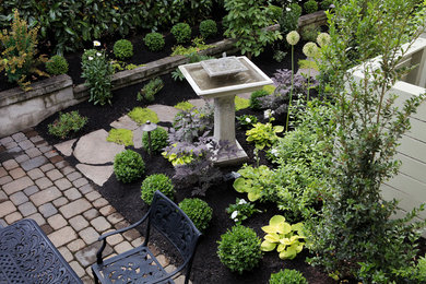 Photo of a mid-sized transitional side yard partial sun garden in Other.
