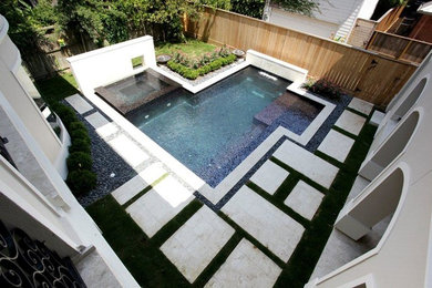 Example of a large minimalist backyard stamped concrete and custom-shaped lap hot tub design in Houston