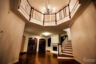 Elegant vaulted ceiling foyer photo with beige walls