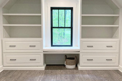 Elegant built-in closet photo in Grand Rapids with raised-panel cabinets and white cabinets