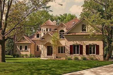 Mid-sized traditional beige two-story brick gable roof idea in Chicago