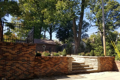 Large elegant backyard concrete paver patio photo in Other with no cover