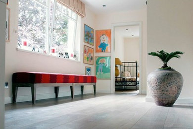 Hallway - huge eclectic dark wood floor hallway idea in New York with beige walls