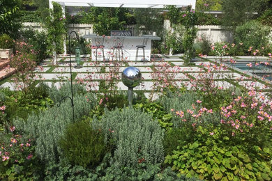 Photo of a mid-sized contemporary full sun backyard concrete paver landscaping in Los Angeles.