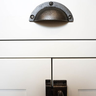 Aménagement d'une petite arrière-cuisine campagne en U avec un évier posé, un placard à porte shaker, des portes de placard blanches, une crédence blanche, une crédence en carrelage métro, un électroménager en acier inoxydable, un sol en bois foncé, un îlot central, un sol marron et un plan de travail en zinc.