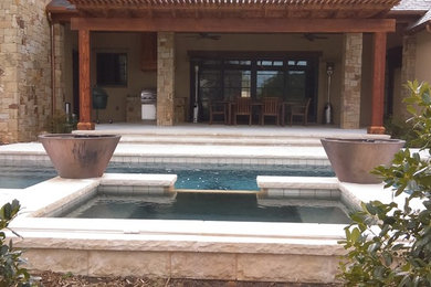 Inspiration for a mid-sized contemporary backyard rectangular and stone lap hot tub remodel in Dallas