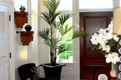 Large elegant medium tone wood floor and brown floor entryway photo in Other with white walls and a medium wood front door