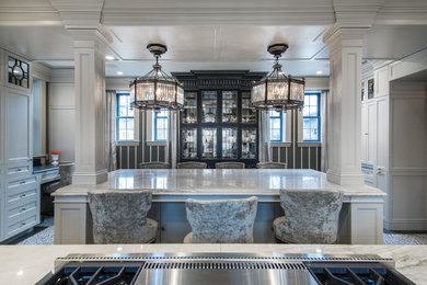 Large elegant porcelain tile enclosed kitchen photo in Cleveland with shaker cabinets, beige cabinets, quartzite countertops, mirror backsplash, stainless steel appliances, two islands and gray countertops