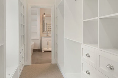 Design ideas for a traditional gender-neutral dressing room in Brisbane with carpet and beige floor.