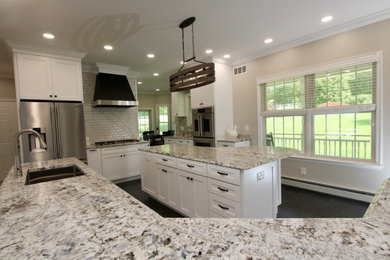 Huge transitional u-shaped slate floor, gray floor and tray ceiling open concept kitchen photo in Baltimore with an undermount sink, shaker cabinets, white cabinets, granite countertops, white backsplash, ceramic backsplash, stainless steel appliances, two islands and gray countertops