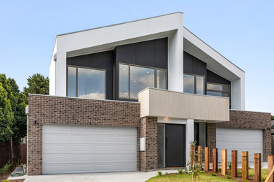 Photo of a large modern two-storey townhouse exterior in Melbourne.