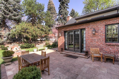 Patio fountain - mid-sized traditional backyard stone patio fountain idea in Denver with no cover