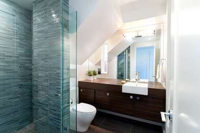 Inspiration for a contemporary blue tile and matchstick tile alcove shower remodel in Vancouver with a drop-in sink, flat-panel cabinets, dark wood cabinets and wood countertops
