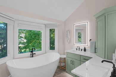 Inspiration for a contemporary double-sink freestanding bathtub remodel in Columbus with green cabinets and white countertops