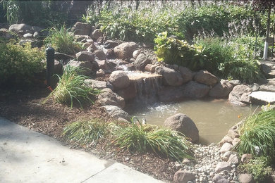 Photo of a mid-sized rustic partial sun backyard gravel landscaping in Other for spring.
