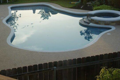 Example of a mid-sized trendy backyard custom-shaped hot tub design in Austin