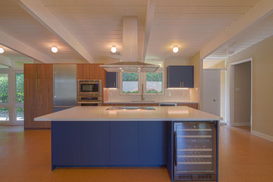 Mid-sized minimalist single-wall cork floor, orange floor and wood ceiling open concept kitchen photo in San Francisco with an undermount sink, flat-panel cabinets, blue cabinets, quartzite countertops, white backsplash, ceramic backsplash, stainless steel appliances, an island and white countertops