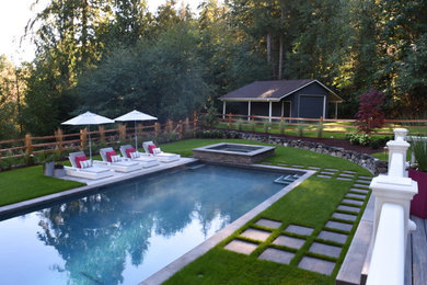 Large contemporary backyard rectangular lap pool in Seattle with a hot tub and concrete pavers.