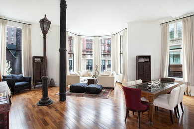 Inspiration for a contemporary open concept medium tone wood floor living room remodel in New York with white walls